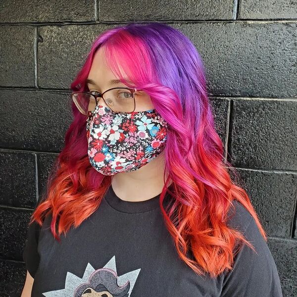 a woman wearing a eyeglasses and printed facemask