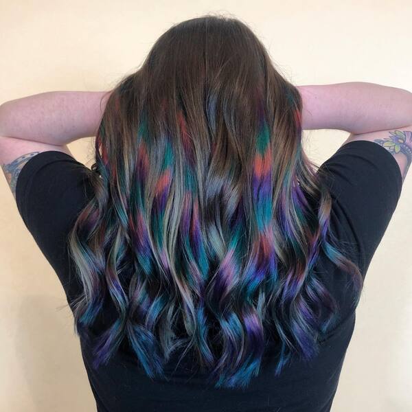 Oil Slick Hair - a woman with tattoo wearing a black shirt