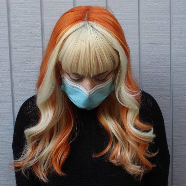 Orange Hair with Blonde Framing - a woman wearing a surgical facemask