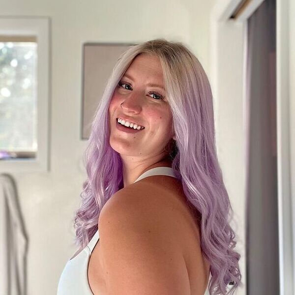 Purple Hair with Middle Part - a woman wearing a white sleeveless shirt