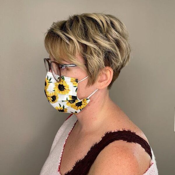 a woman with eyeglasses wearing a printed facemask