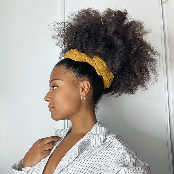 Afro Puff with Headband - a woman wearing a stripe polo longsleeve