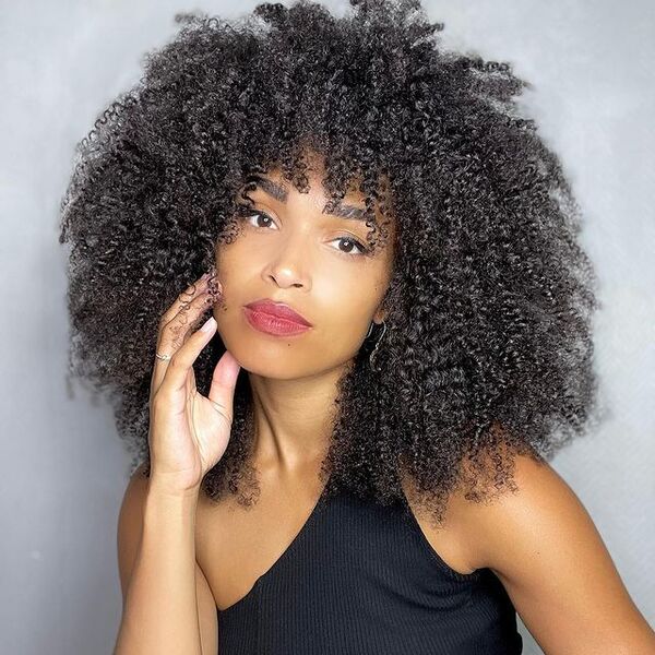 Black Fluffy Afro Hair - a woman wearing a black off shoulder top