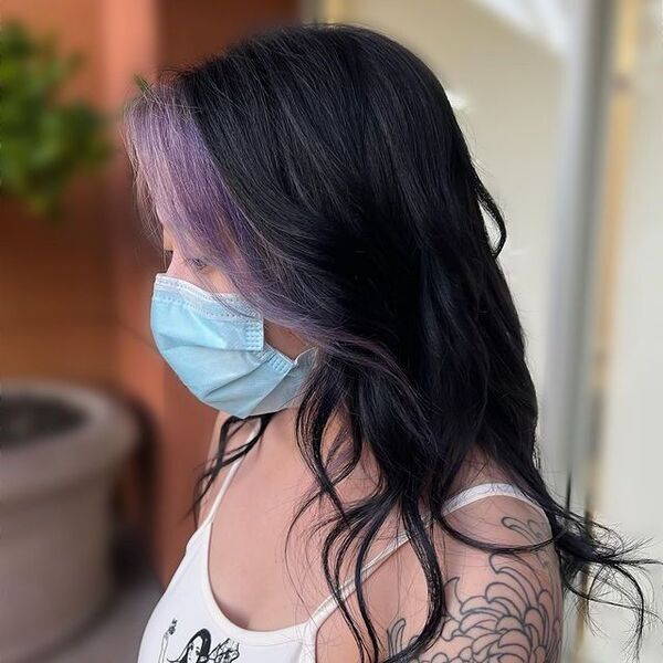 a woman with tattoo wearing a surgical facemask