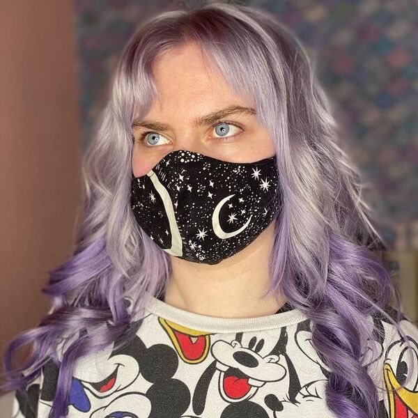 a woman wearing a black printed facemask