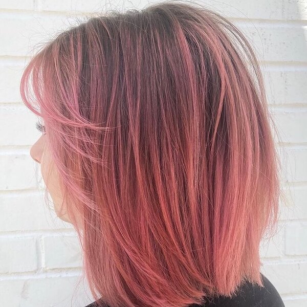 pink ombre hair - a woman facing the wall wearing black shirt