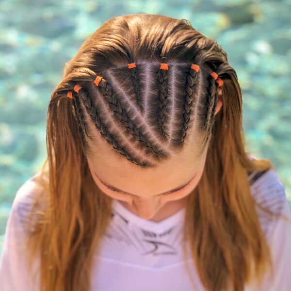 Half Up Cornrow Braids - a woman wearing a white shirt