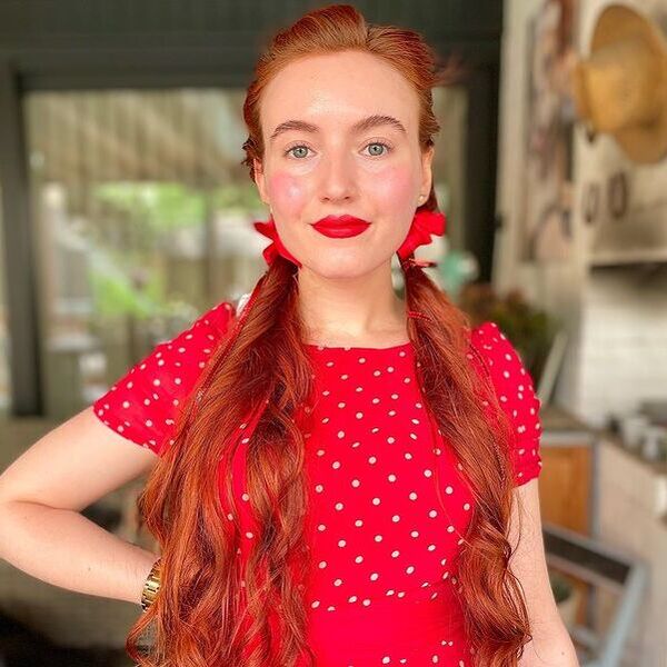 Long Pigtails Hairstyle with Waves - a woman wearing a red polka dots dress
