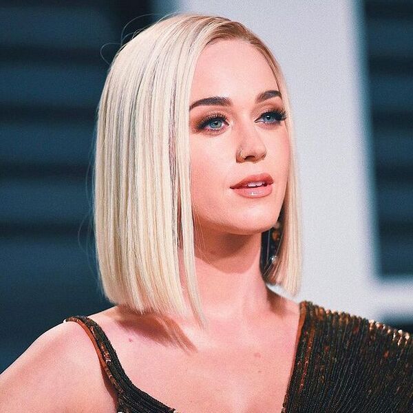 Katy Perry Hair - Side-Parted Blunt Bob Cut - a woman wearing a black and red sexy dress