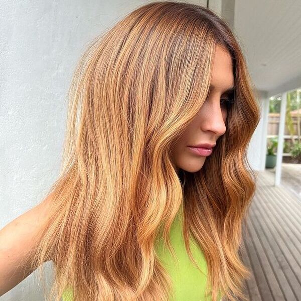 a woman wearing a apple green top and copper balayage
