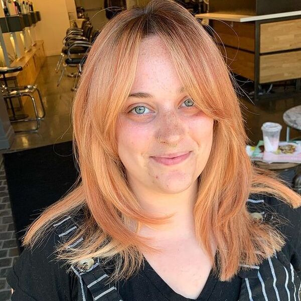 Soft Peachy Tone Hairstyle - a woman inside a salon