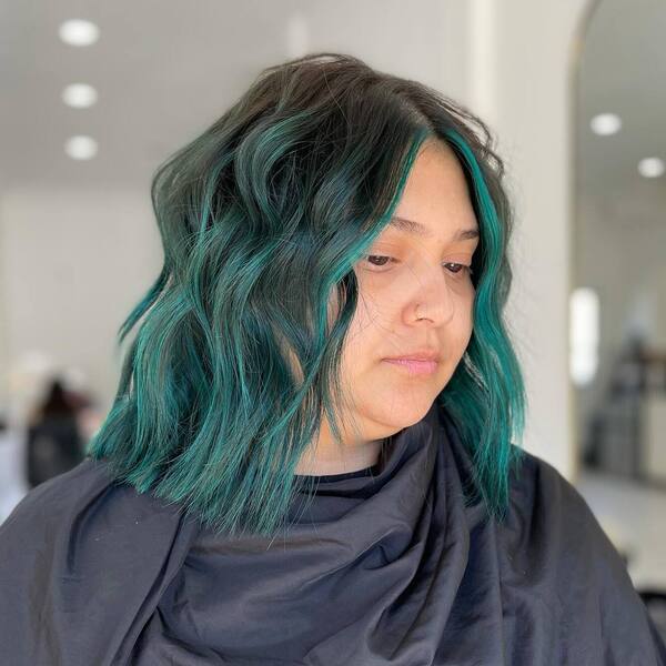 Teal-Green Turquoise Hairstyle - a woman wearing a black cape