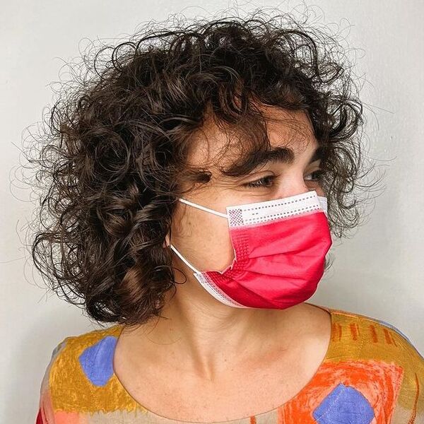 Textured Curly Bob - a woman wearing a red facemask