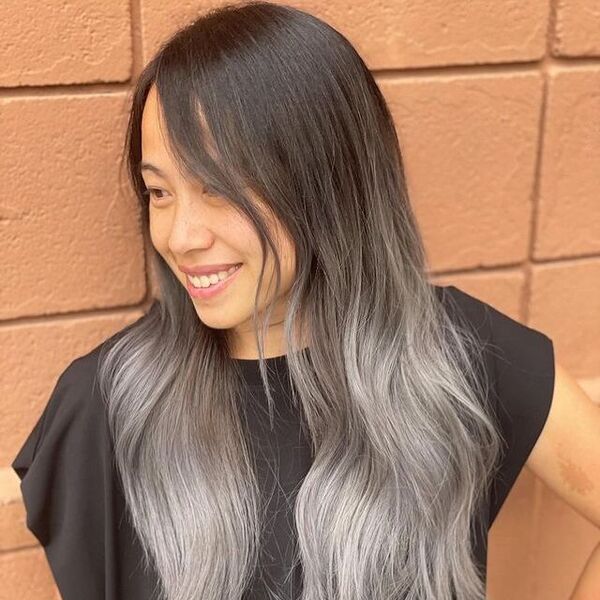 a woman with silver ombre hair wearing a black dress