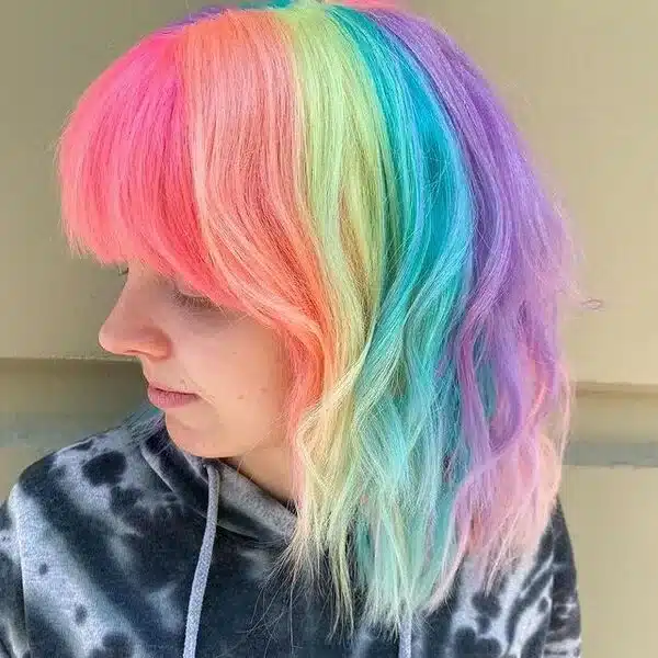 Stunning Rainbow Cotton Candy Hair - a woman wearing a tie dye jacket