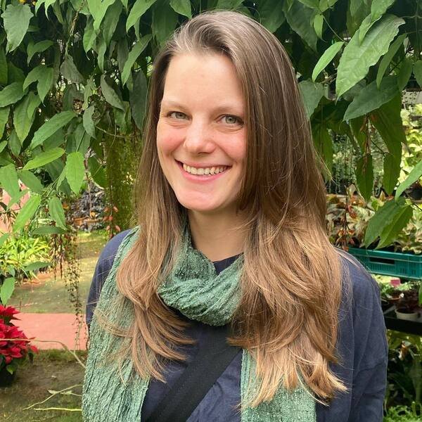 A woman wearing green scarf and sweat shirt