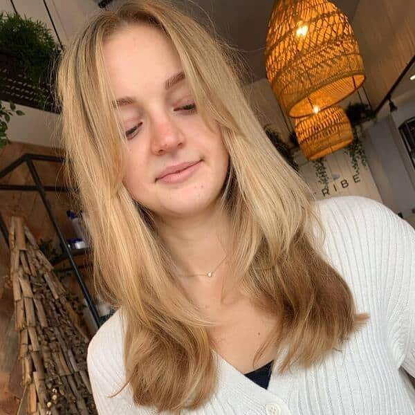 A woman wearing white knitted top