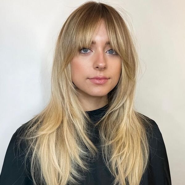 A woman wearing a black salon cape