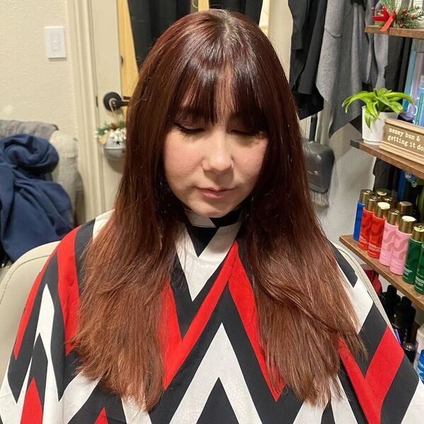 A woman wearing a salon cape