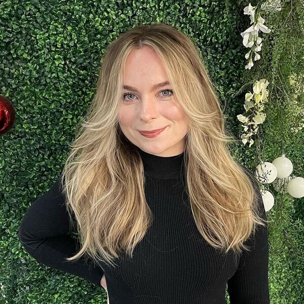 A woman wearing knitted black turtle neck top