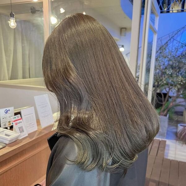 A woman wearing a black salon cape