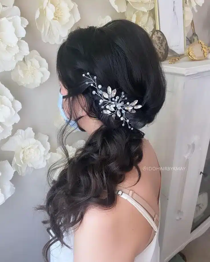 Side ponytail hairstyle with flower clip